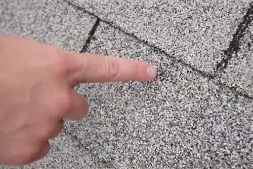 Closeup view of damaged shingle.
