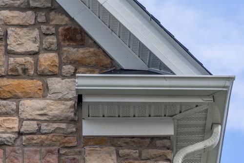 View of soffits and fascia on brick home.